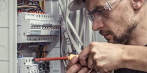 electrician fixing subpanel in home