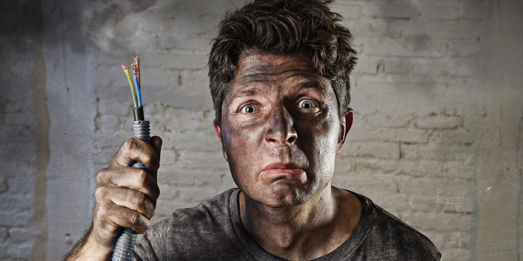 young-man-holding-electricity-cable-smoking